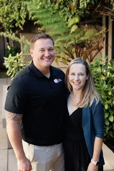 Parents of a child with GM1 gangliosidosis smiling outdoors
