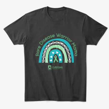 A shirt has a rainbow in the brand colors of the Cure GM1 Foundation. Across the top of the rainbow it says, "Rare Disease Warrior Mama"