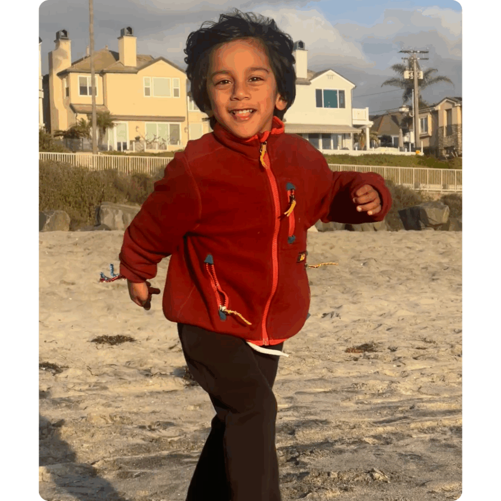 Kiaan skips happily along the beach