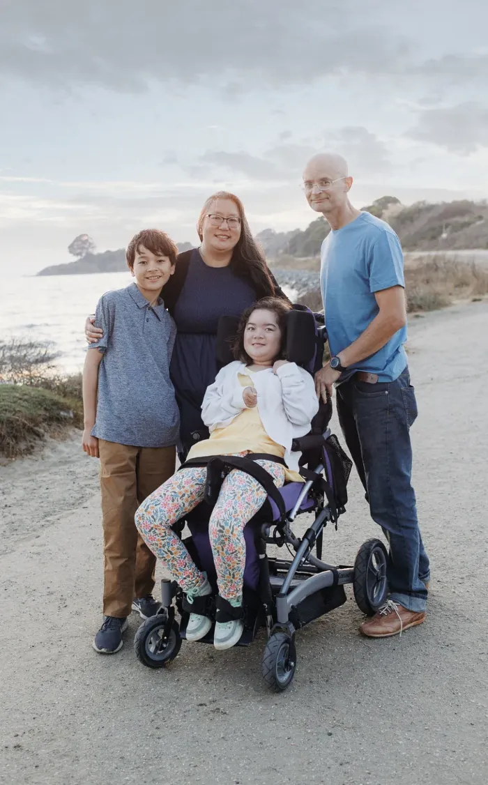 Christine Waggoner, founder of Cure GM1, with her family on a coastal path