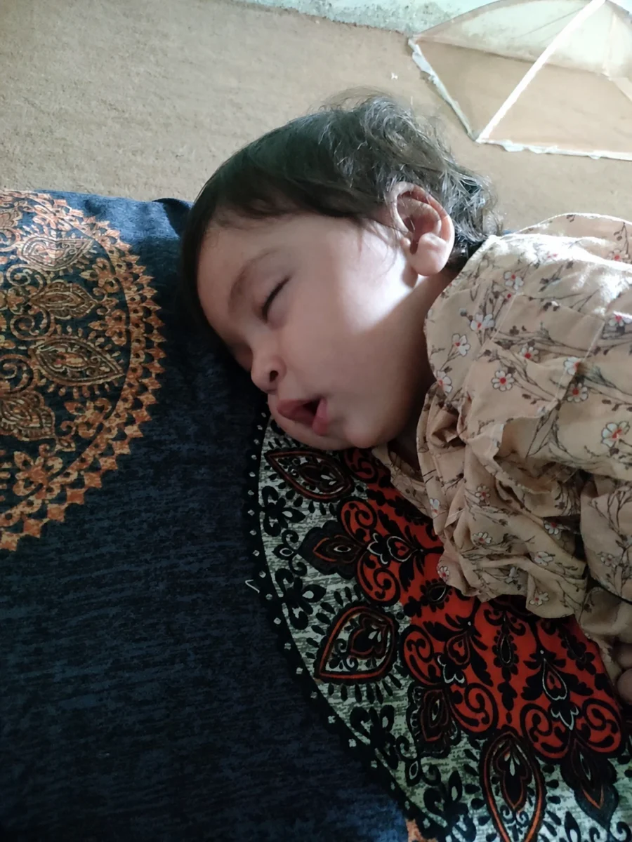 Ayesha sleeping on patterned blankets
